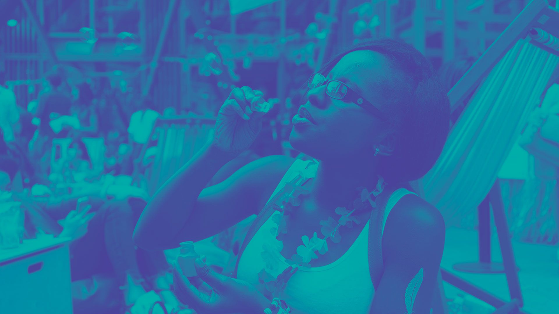 A student blowing bubbles at an outdoor event