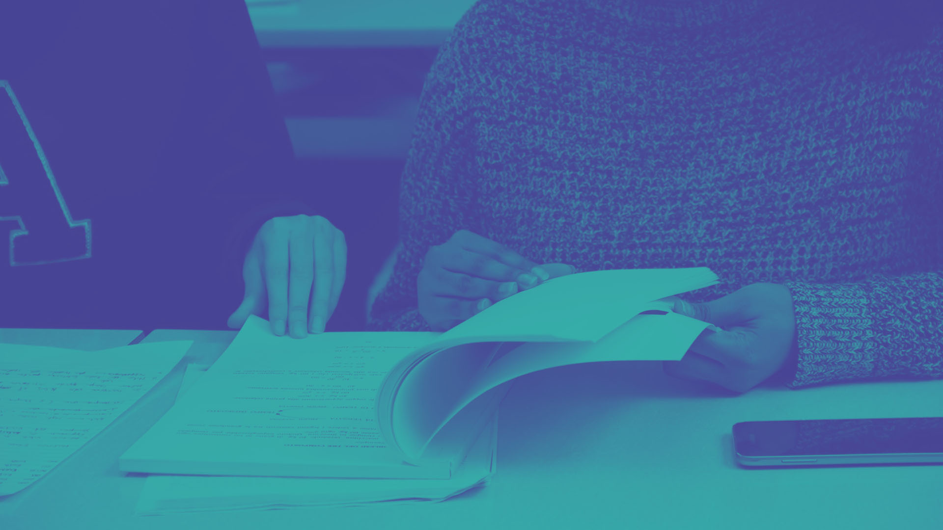 Two students are sat reviewing their academic papers for appeal