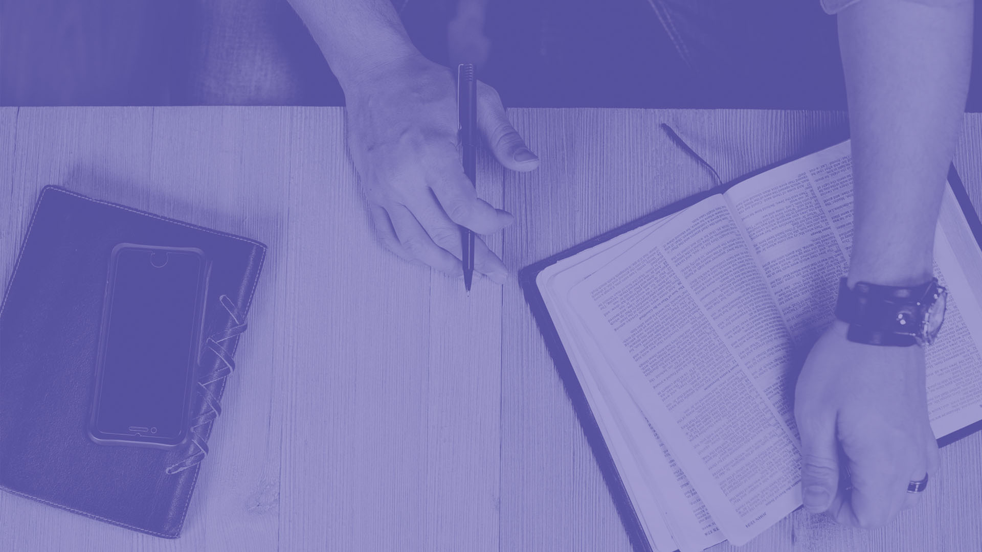 A student is sat with their diary and phone writing down information