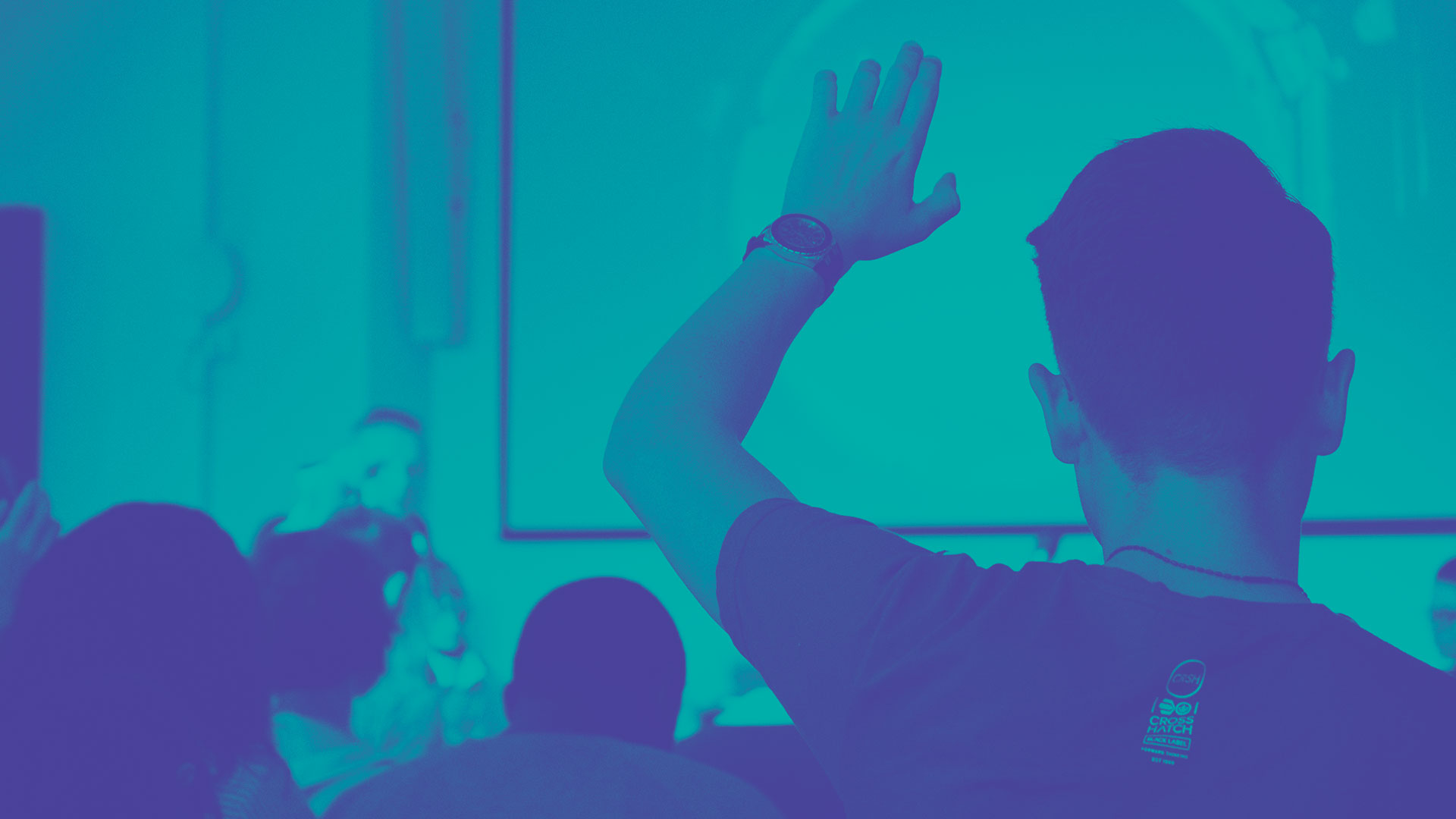 A student raising their hand in class