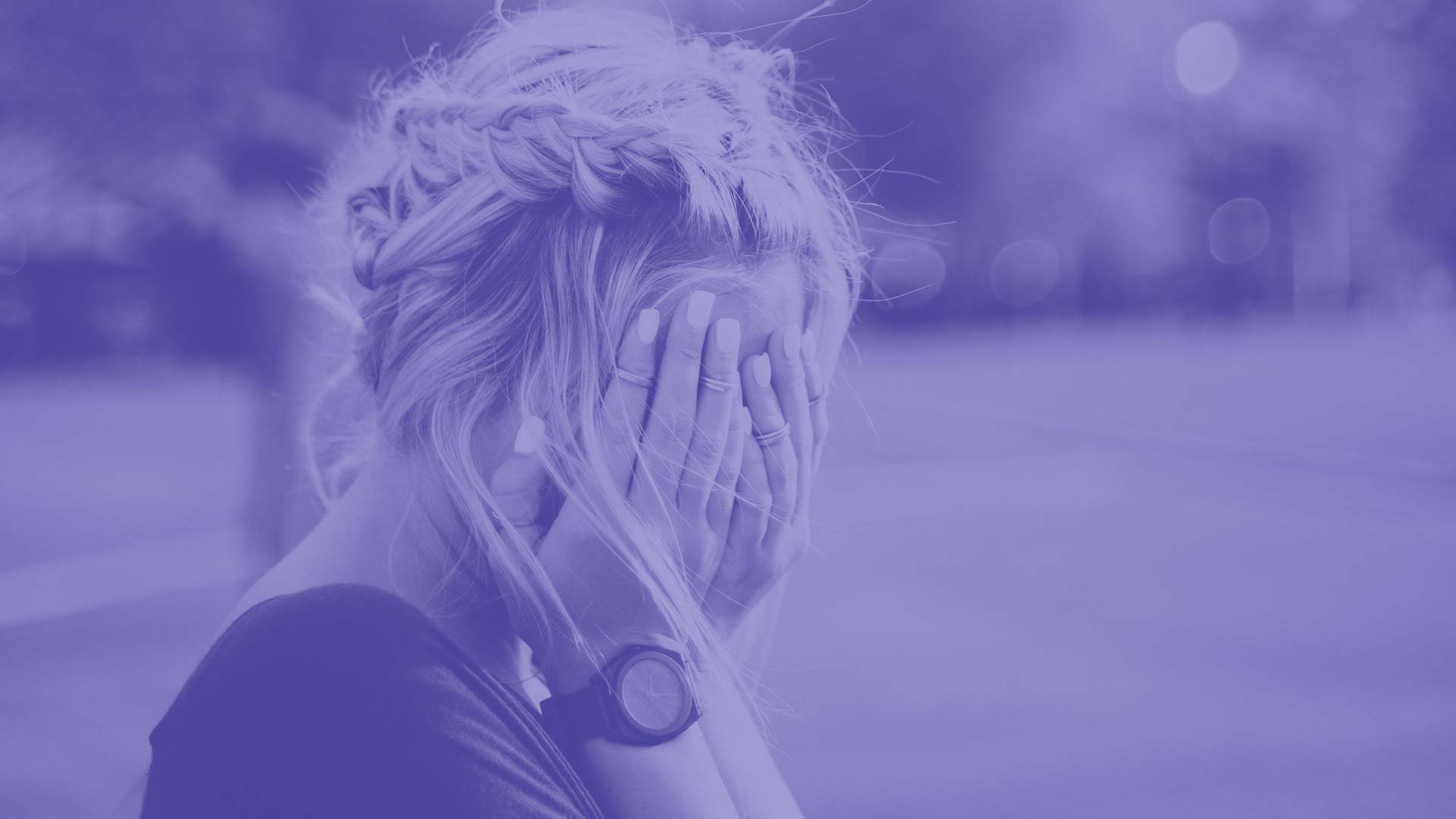 A student covering their hands with their face