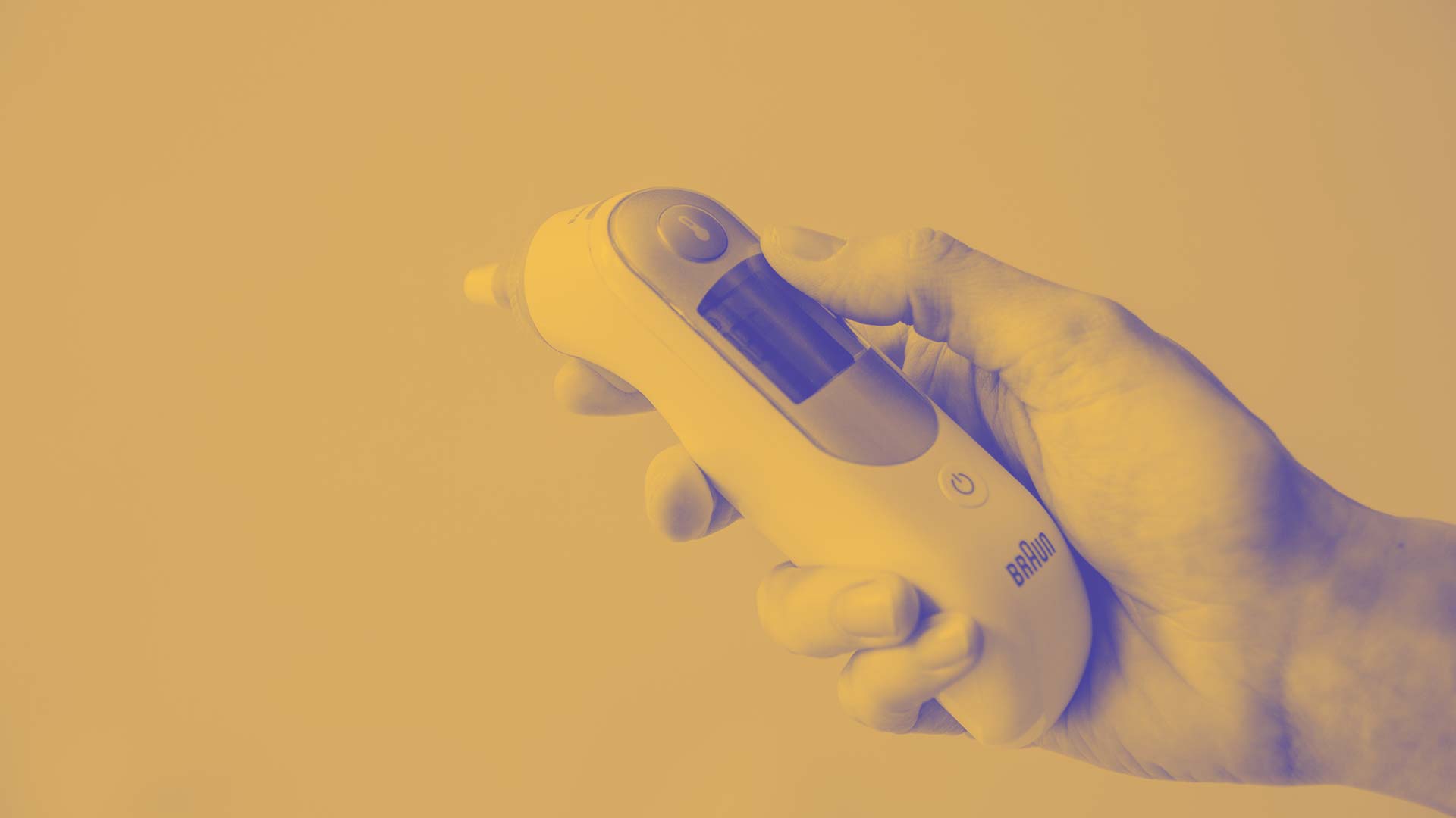 A person holding a thermometer