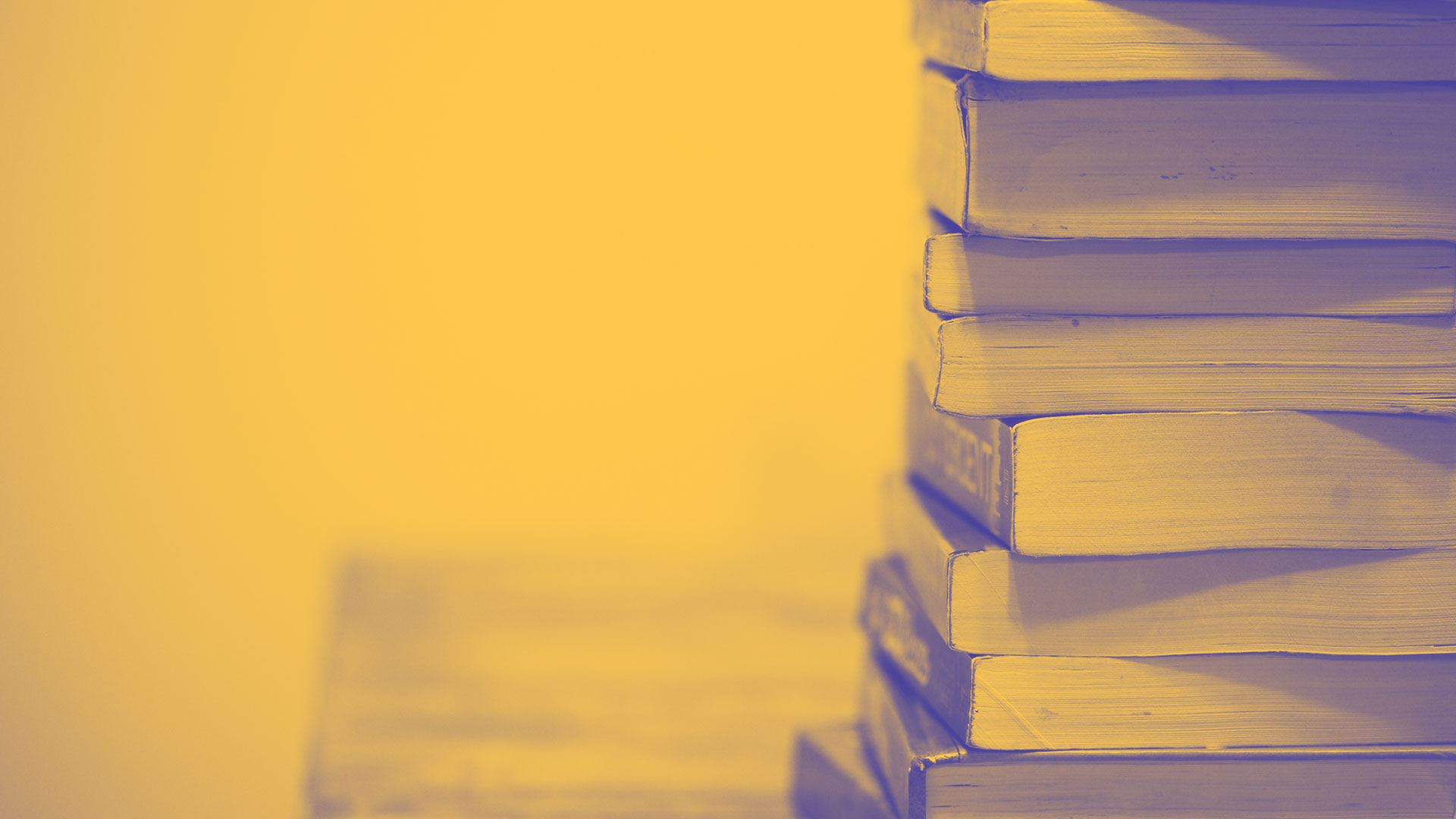A pile of books on a desk