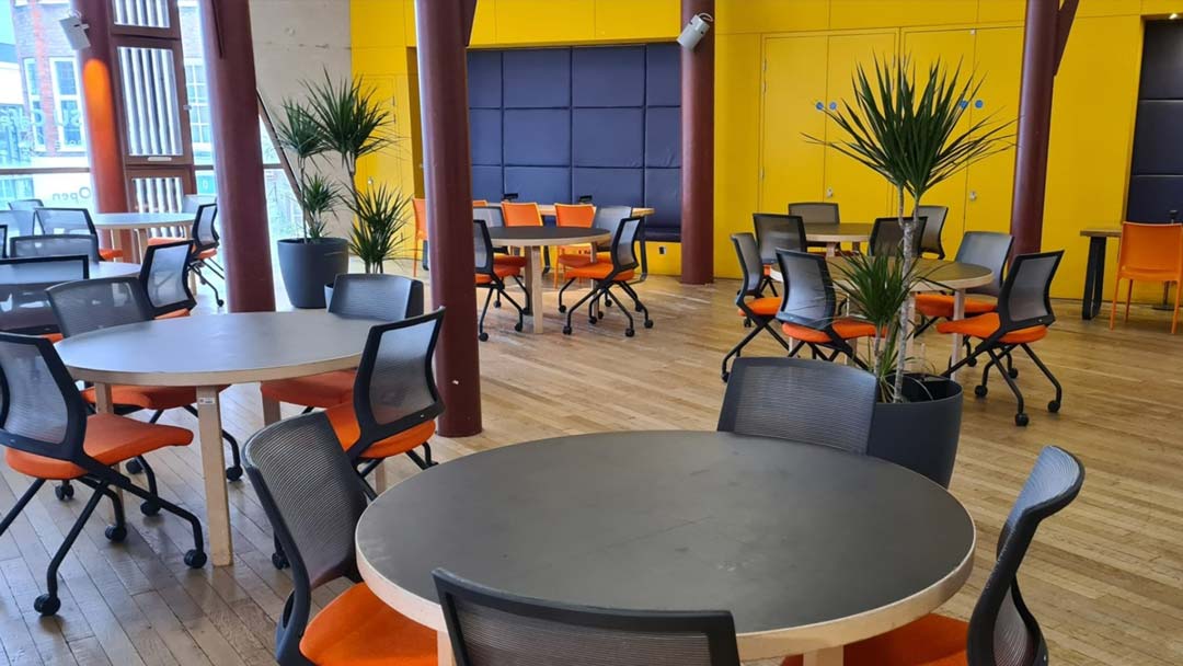 A photograph of The Arc showing chairs set out ready to watch a movie on a projector screen