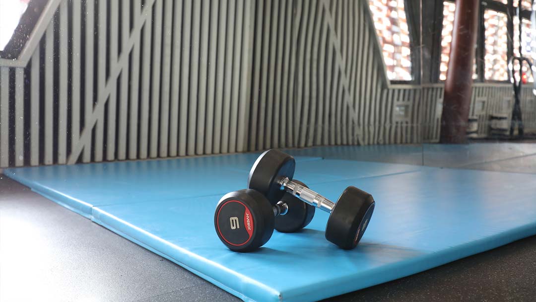 The LSESU gym, you can see dumbbells resting on a blue gym mat