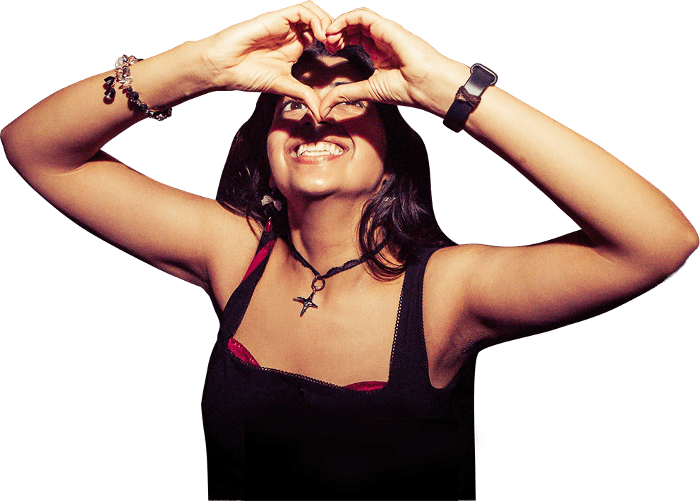A student at a Summer School event holding her hands in a heart shape