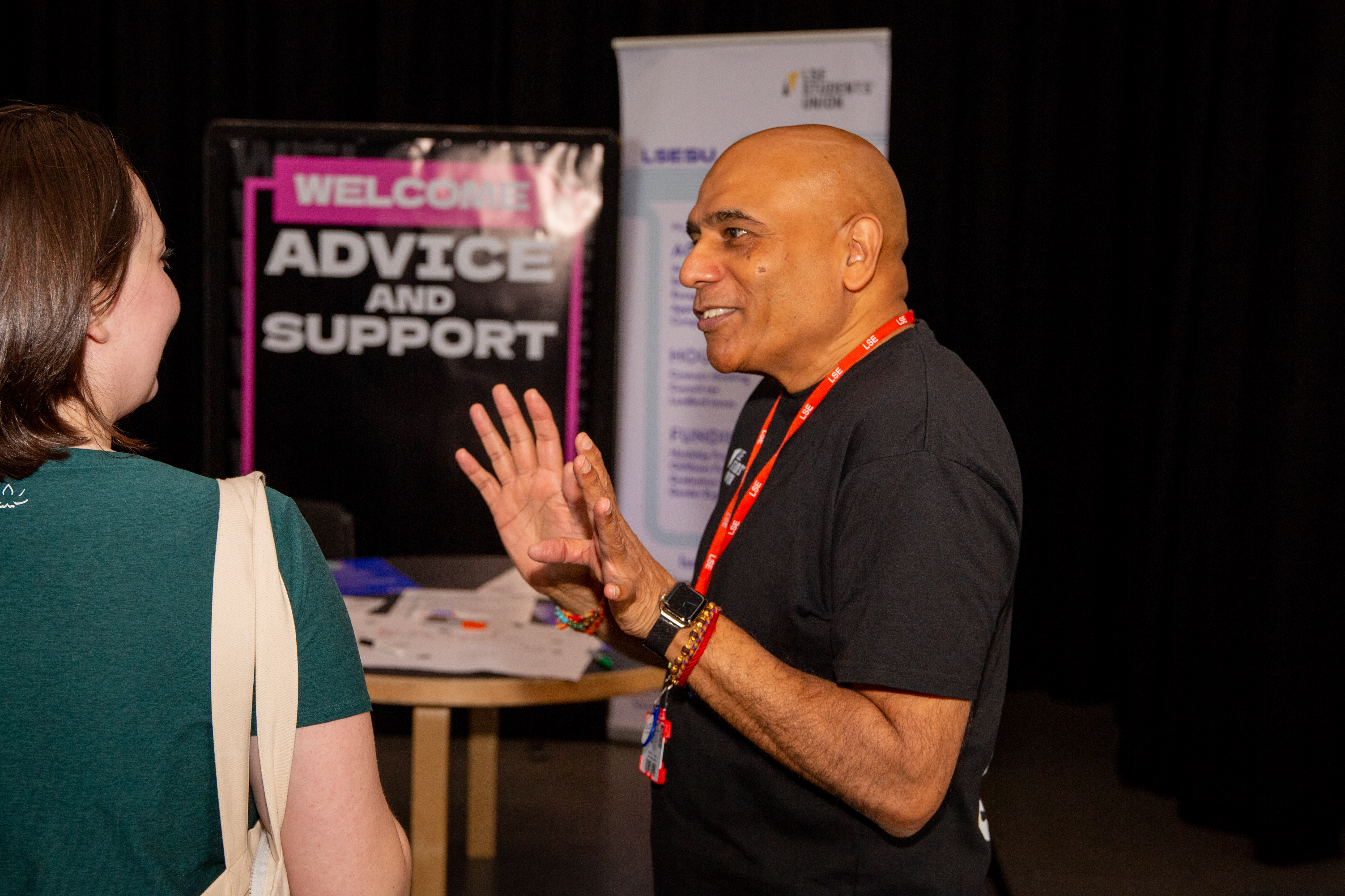 LSESU's Advice Team at Welcome Fair, posing next to a banner and smiling