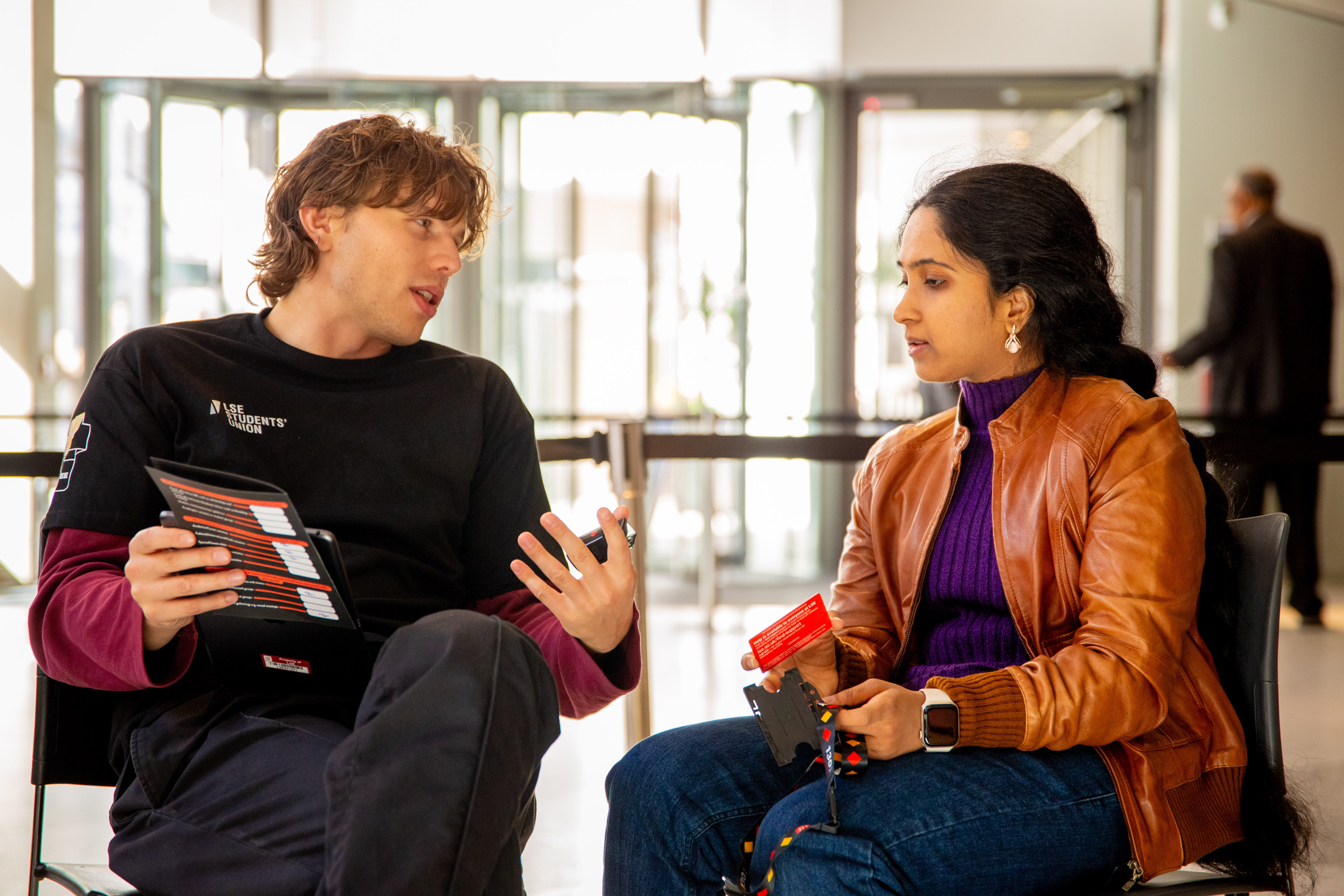 A student talking to a staff member inside of the Marshall Building