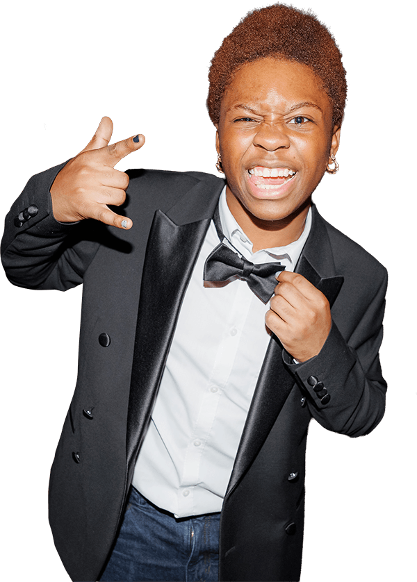 A student dancing at an event wearing a smart suit