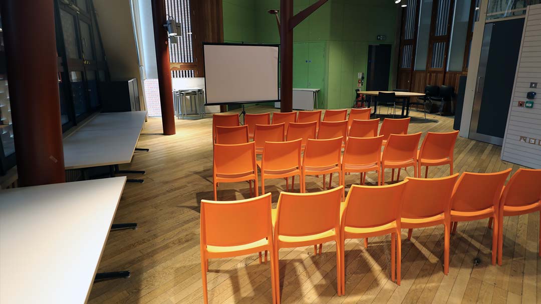 A photograph of The Arc showing chairs set out ready to watch a movie on a projector screen